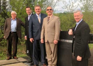 Representatives of the provincial and federal government joined BWS company officials on May 14, 2013 to celebrate BWS Manufacturing's new facility and to announce provincial and federal investments to help the company acquire a neighbouring manufacturing facility to establish a new plant. From left to right: Dale Graham, Speaker of the Legislative Assembly; Victoria-Tobique MLA Wes McLean; Premier David Alward; BWS president Randy MacDougall; and Tobique-Mactaquac MP Mike Allen. Photo by the Government of New Brunswick. 