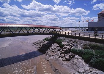 The Petitcodiac River and footbridge in Moncton. Photo by Brian Atkinson from the Images of New Brunswick database.