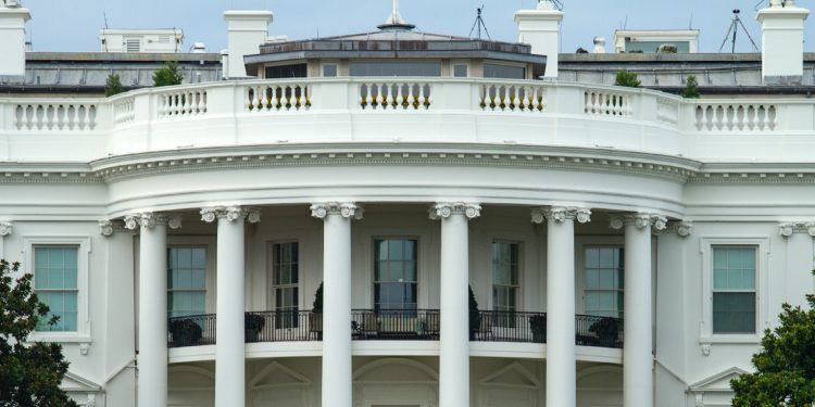 A close-up view of the central facade of the White House, with its columns and balconies.