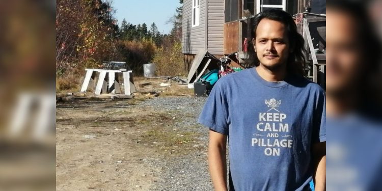Nick Polchies stands in front of his home on the proposed mining site.