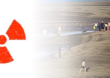 A group of people are gathered on a dirt mound. A red radioactive symbol is next to them.