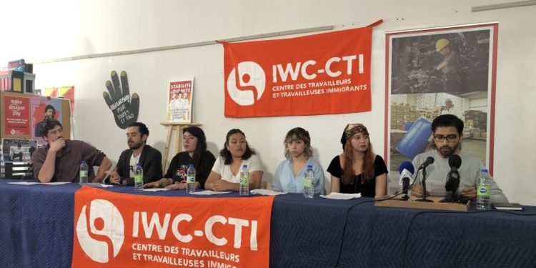 A group of people sitting at a IWC table.
